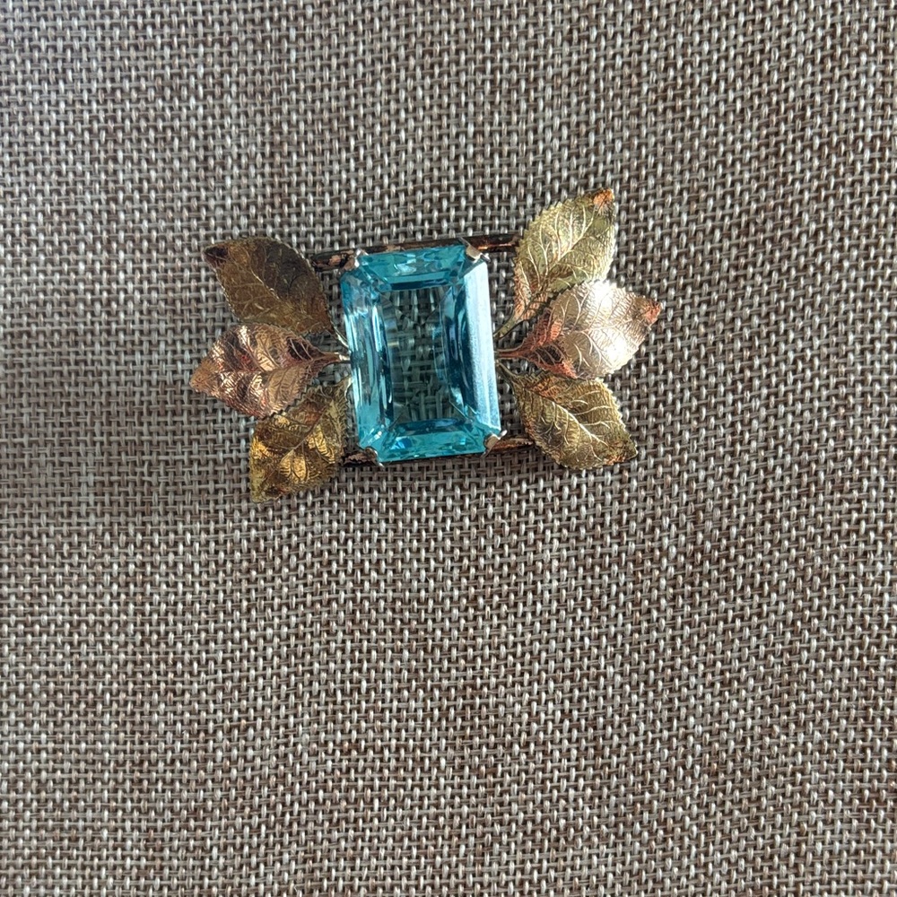 vintage yellow and rose gold-plated aqua rhinestone brooch, circa 1940.